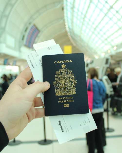 canadian passport in airport hands